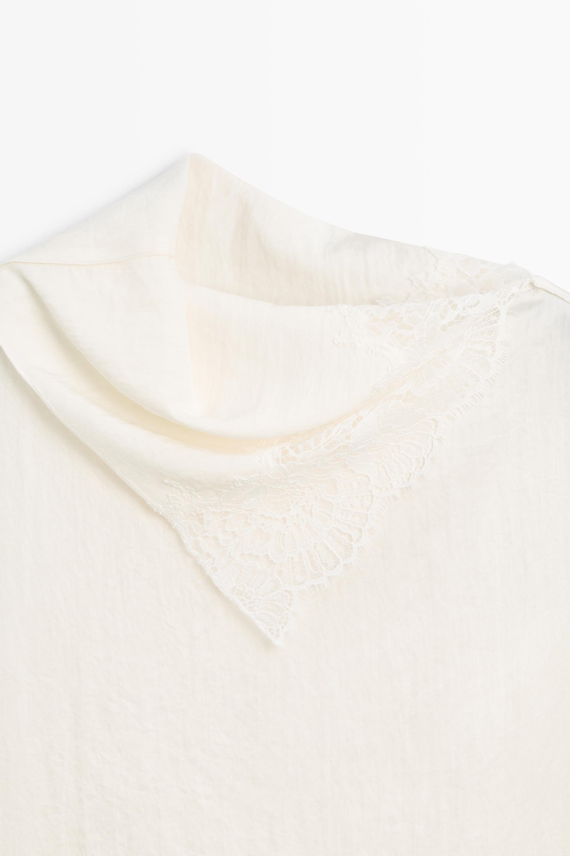 Asymmetric roll neck top with lace detail
